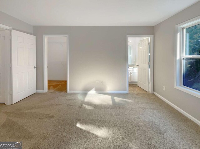 2555 Flat Shoals Rd Unit 3405, Atlanta, GA 30349 - unfurnished bedroom featuring carpet, a walk in closet, and ensuite bathroom