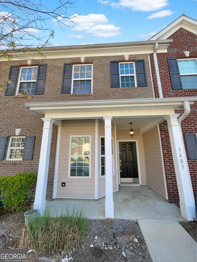 2555 Flat Shoals Rd Unit 3405, Atlanta, GA 30349 - view of front of property with covered porch and brick siding