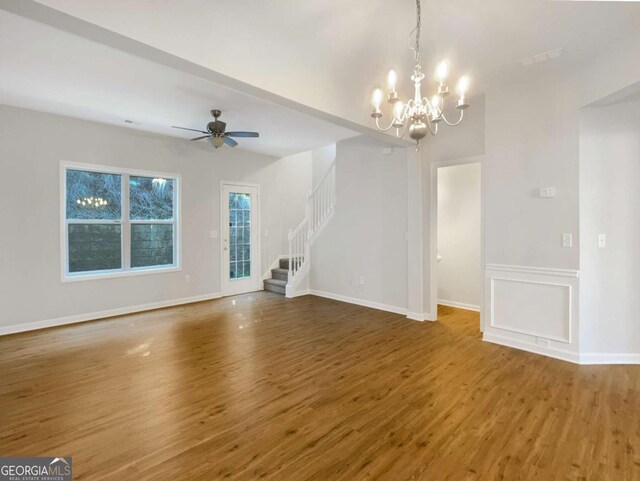 2555 Flat Shoals Rd Unit 3405, Atlanta, GA 30349 - unfurnished living room featuring stairs, wood finished floors, a chandelier, and ceiling fan