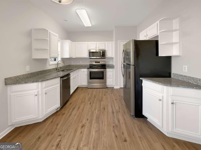 2555 Flat Shoals Rd Unit 3405, Atlanta, GA 30349 - kitchen with appliances with stainless steel finishes, open shelves, light wood-style floors, and white cabinetry
