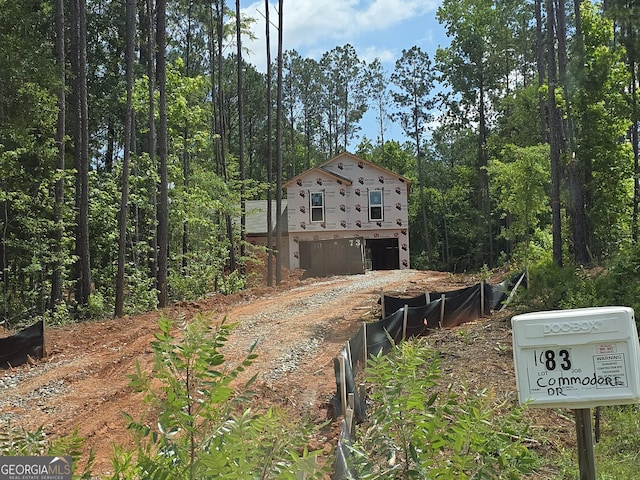 52 Armstrong Dr Unit 83, Mansfield, GA 30055 - rear view of property featuring dirt driveway and a garage