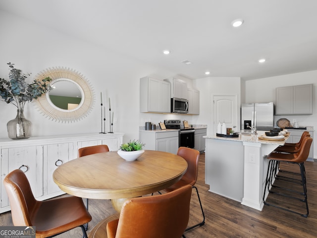 8215 Coldstream Dr, Fairburn, GA 30213 - dining area featuring dark wood-style flooring and recessed lighting