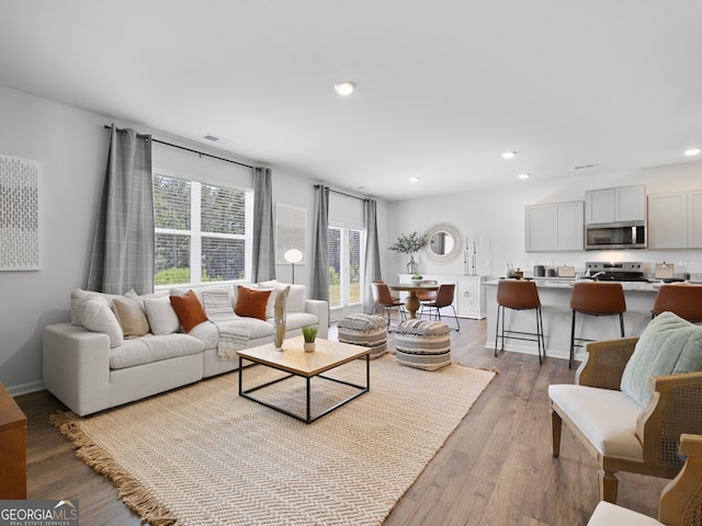 8215 Coldstream Dr, Fairburn, GA 30213 - living area with wood finished floors and recessed lighting