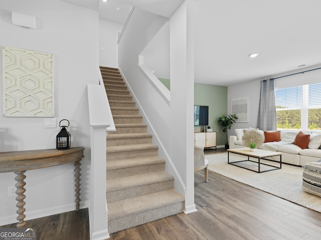 8215 Coldstream Dr, Fairburn, GA 30213 - stairs featuring wood finished floors, recessed lighting, and baseboards