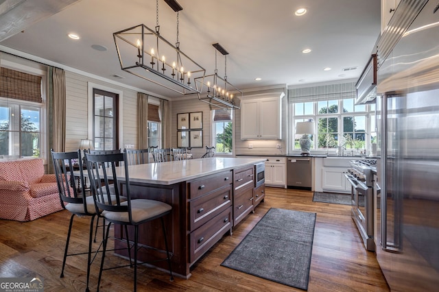 3315 Chandler Rd, Good Hope, GA 30641 - kitchen with built in appliances, white cabinets, a kitchen breakfast bar, recessed lighting, and dark wood-type flooring