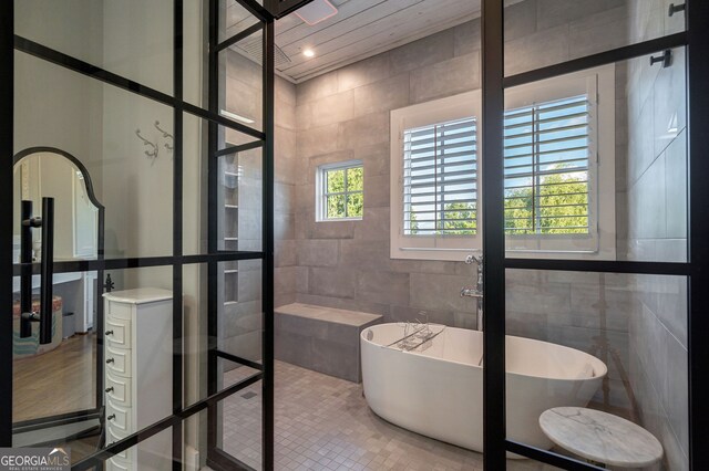 3315 Chandler Rd, Good Hope, GA 30641 - full bath with tile walls, vanity, a freestanding tub, and a tile shower