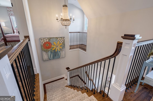 3315 Chandler Rd, Good Hope, GA 30641 - stairway featuring wood finished floors, a chandelier, plenty of natural light, and lofted ceiling