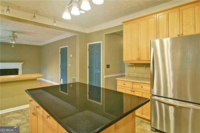 2212 Mcquiston Dr SW, Marietta, GA 30064 - kitchen with freestanding refrigerator, ceiling fan, a fireplace, light brown cabinets, and a chandelier