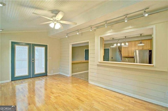 2212 Mcquiston Dr SW, Marietta, GA 30064 - unfurnished living room with rail lighting, french doors, ceiling fan, wood finished floors, and wooden walls