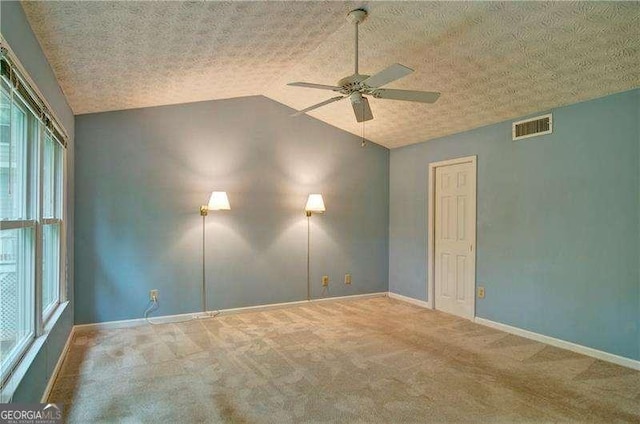 2212 Mcquiston Dr SW, Marietta, GA 30064 - empty room with a ceiling fan, vaulted ceiling, carpet, healthy amount of natural light, and baseboards