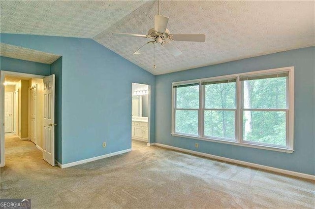 2212 Mcquiston Dr SW, Marietta, GA 30064 - unfurnished bedroom featuring baseboards, vaulted ceiling, carpet, ensuite bathroom, and a textured ceiling