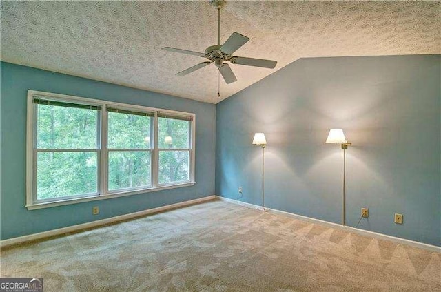2212 Mcquiston Dr SW, Marietta, GA 30064 - spare room featuring lofted ceiling, carpet floors, a textured ceiling, baseboards, and ceiling fan
