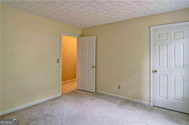 2212 Mcquiston Dr SW, Marietta, GA 30064 - unfurnished bedroom with carpet flooring, a textured ceiling, and baseboards