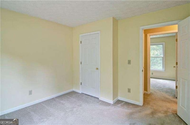 2212 Mcquiston Dr SW, Marietta, GA 30064 - unfurnished bedroom featuring carpet, a textured ceiling, and baseboards
