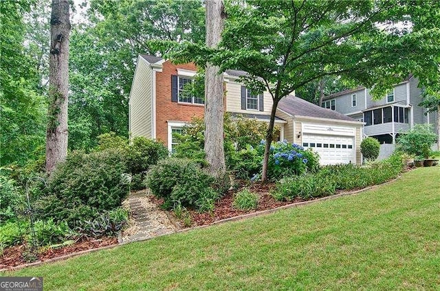 2212 Mcquiston Dr SW, Marietta, GA 30064 - view of front of house featuring a front lawn, brick siding, and a garage