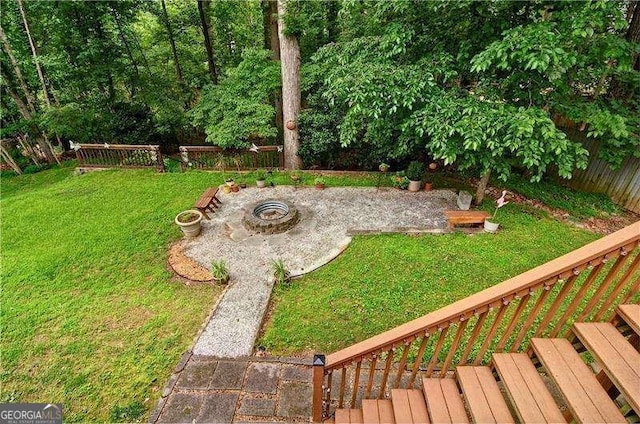 2212 Mcquiston Dr SW, Marietta, GA 30064 - view of green lawn with a patio and an outdoor fire pit
