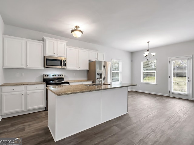 789 Galveston Way, Mcdonough, GA 30253 - kitchen with appliances with stainless steel finishes, white cabinetry, a center island with sink, and a chandelier