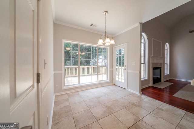 70 Sylvia Cir, Covington, GA 30016 - unfurnished dining area with light tile patterned floors, a chandelier, a fireplace with flush hearth, crown molding, and baseboards