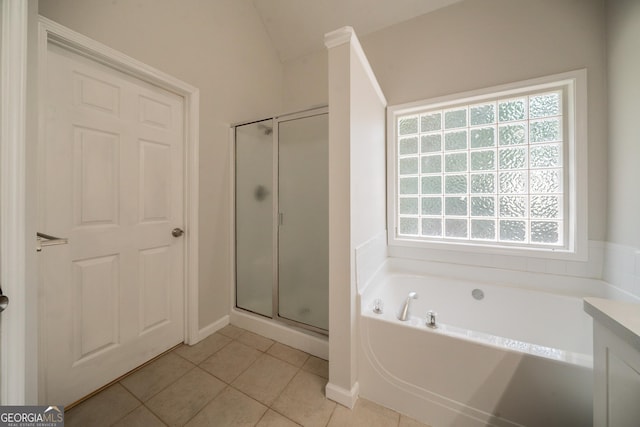 70 Sylvia Cir, Covington, GA 30016 - bathroom featuring healthy amount of natural light, a stall shower, tile patterned floors, a bath, and lofted ceiling
