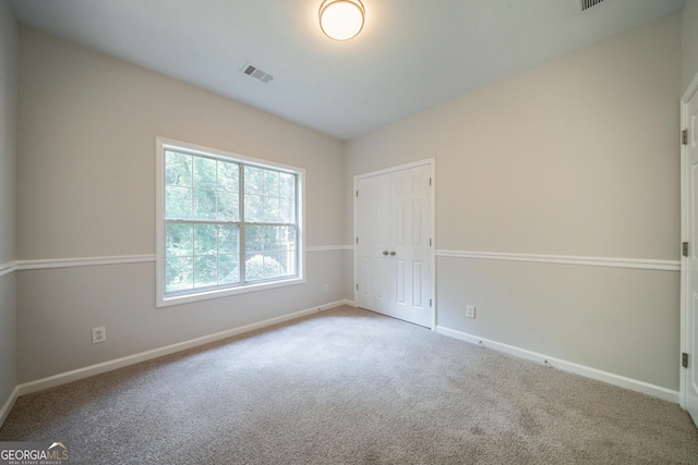 70 Sylvia Cir, Covington, GA 30016 - unfurnished bedroom with carpet floors, baseboards, and a closet
