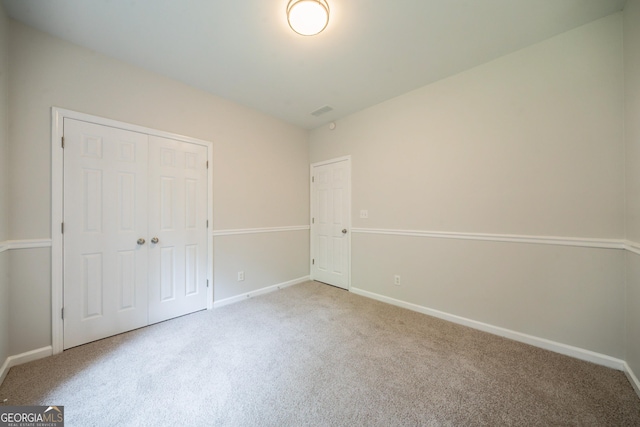 70 Sylvia Cir, Covington, GA 30016 - unfurnished bedroom featuring carpet flooring, baseboards, and a closet
