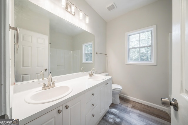 70 Sylvia Cir, Covington, GA 30016 - bathroom with plenty of natural light, double vanity, toilet, and baseboards