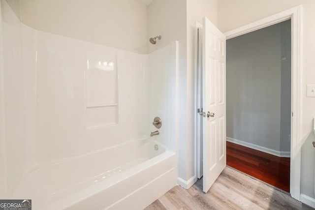 70 Sylvia Cir, Covington, GA 30016 - bathroom with wood finished floors,  shower combination, and baseboards