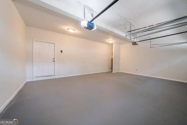 70 Sylvia Cir, Covington, GA 30016 - garage featuring a garage door opener and baseboards