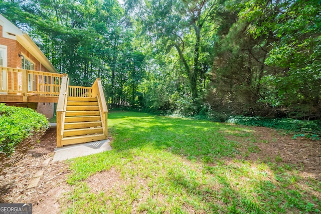 70 Sylvia Cir, Covington, GA 30016 - view of grassy yard featuring stairway and a deck