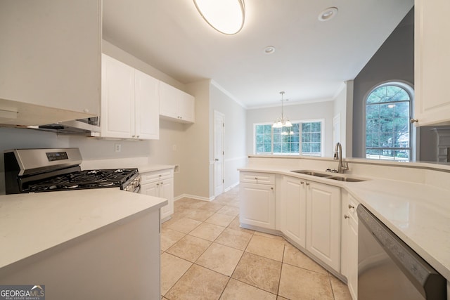 70 Sylvia Cir, Covington, GA 30016 - kitchen with stainless steel appliances, a sink, white cabinetry, ornamental molding, and plenty of natural light