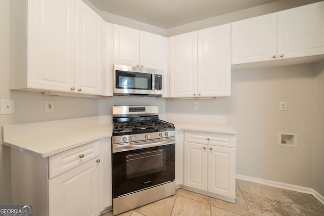 70 Sylvia Cir, Covington, GA 30016 - kitchen with appliances with stainless steel finishes, baseboards, light countertops, and white cabinets
