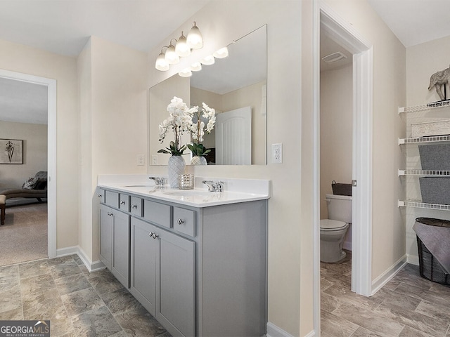 366 Lost Creek Blvd, Dallas, GA 30132 - bathroom featuring double vanity, toilet, connected bathroom, and baseboards