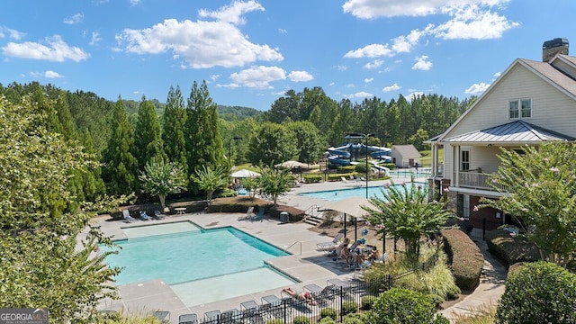 366 Lost Creek Blvd, Dallas, GA 30132 - community pool with a water slide and a patio