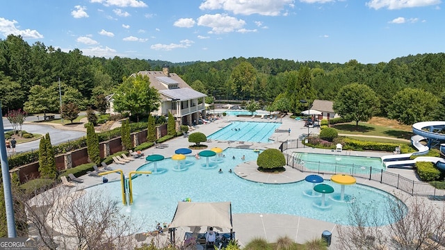 366 Lost Creek Blvd, Dallas, GA 30132 - community pool with a water play area, a water slide, a view of trees, and a patio area
