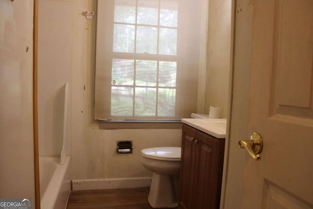 8469 Shiloh Ct, Jonesboro, GA 30238 - full bathroom with vanity, toilet, wood finished floors, baseboards, and washtub / shower combination