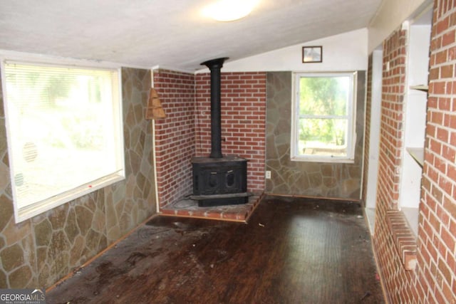 8469 Shiloh Ct, Jonesboro, GA 30238 - unfurnished living room with a wood stove, wood-type flooring, and lofted ceiling