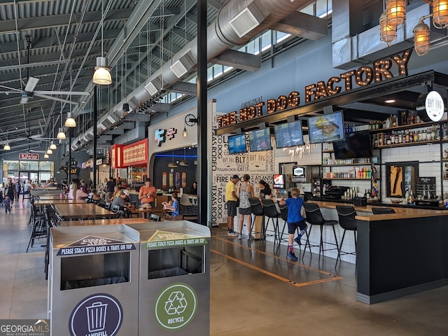 7850 Willoughby Ct, Alpharetta, GA 30005 - misc room featuring concrete flooring, a community bar, and a towering ceiling