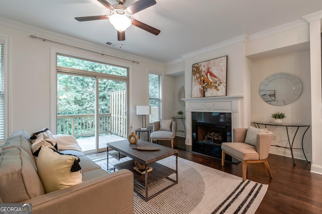 7850 Willoughby Ct, Alpharetta, GA 30005 - living area featuring dark wood-style floors, crown molding, plenty of natural light, a fireplace with raised hearth, and a ceiling fan