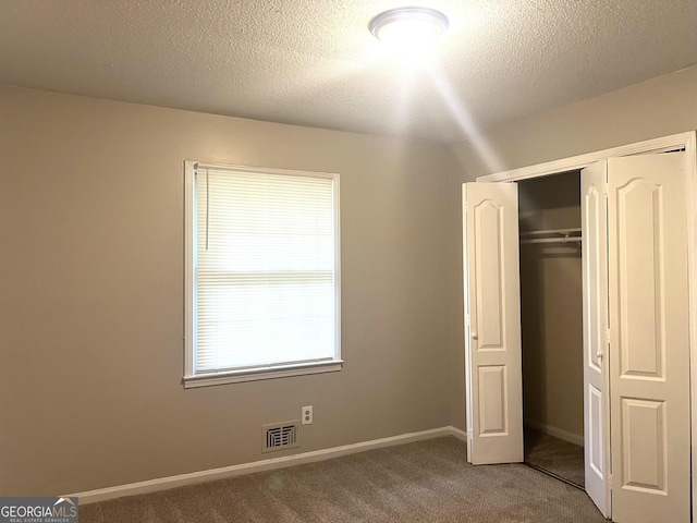4196 Lehigh Blvd, Decatur, GA 30034 - unfurnished bedroom featuring carpet, a closet, a textured ceiling, and baseboards