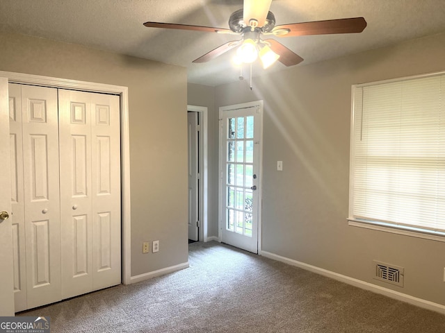 4196 Lehigh Blvd, Decatur, GA 30034 - unfurnished bedroom with carpet, baseboards, a closet, and a ceiling fan