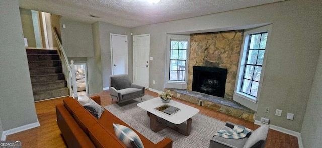 3226 Bruckner Blvd, Snellville, GA 30078 - living room featuring a textured ceiling, healthy amount of natural light, and wood finished floors