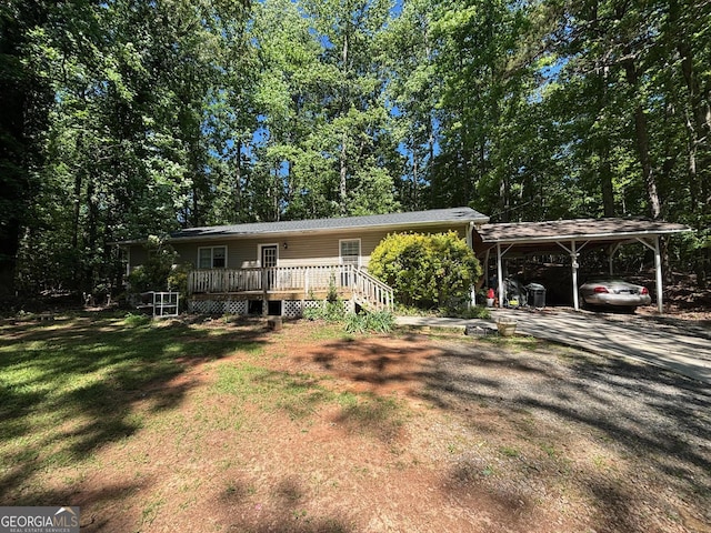 992 Tom Bell Rd, Cleveland, GA 30528 - view of front of house featuring a carport, a wooden deck, a front lawn, and driveway