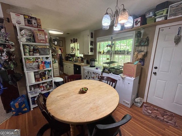 992 Tom Bell Rd, Cleveland, GA 30528 - dining area with wood finished floors, a chandelier, and a textured ceiling