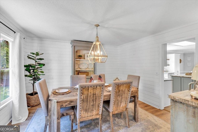 15 Split Oak Dr SW, Cartersville, GA 30120 - dining room featuring a chandelier, light wood-style floors, and wood walls