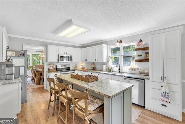 15 Split Oak Dr SW, Cartersville, GA 30120 - kitchen with stainless steel appliances, a sink, a textured ceiling, healthy amount of natural light, and white cabinetry