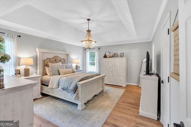 15 Split Oak Dr SW, Cartersville, GA 30120 - bedroom featuring a raised ceiling, a chandelier, light wood-style floors, crown molding, and baseboards