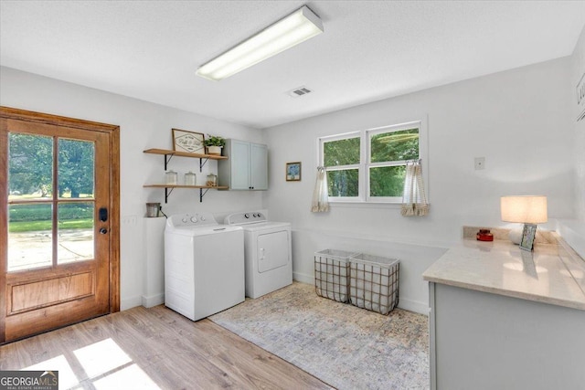 15 Split Oak Dr SW, Cartersville, GA 30120 - laundry area with cabinet space, washing machine and clothes dryer, light wood finished floors, and baseboards