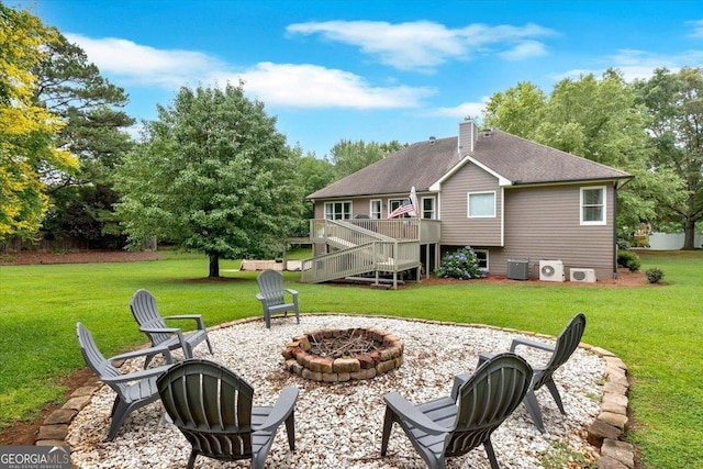 15 Split Oak Dr SW, Cartersville, GA 30120 - rear view of house featuring an outdoor fire pit, a deck, and a lawn