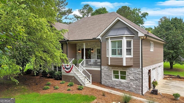 15 Split Oak Dr SW, Cartersville, GA 30120 - view of front of property with stone siding, a porch, driveway, and a garage