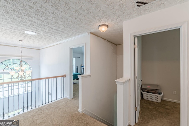 118 Surge Stone Ln, Stockbridge, GA 30281 - hallway with a chandelier, carpet floors, an upstairs landing, and crown molding